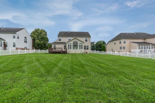 A photo of a house and its newly manicured lawn on a nice spring day.